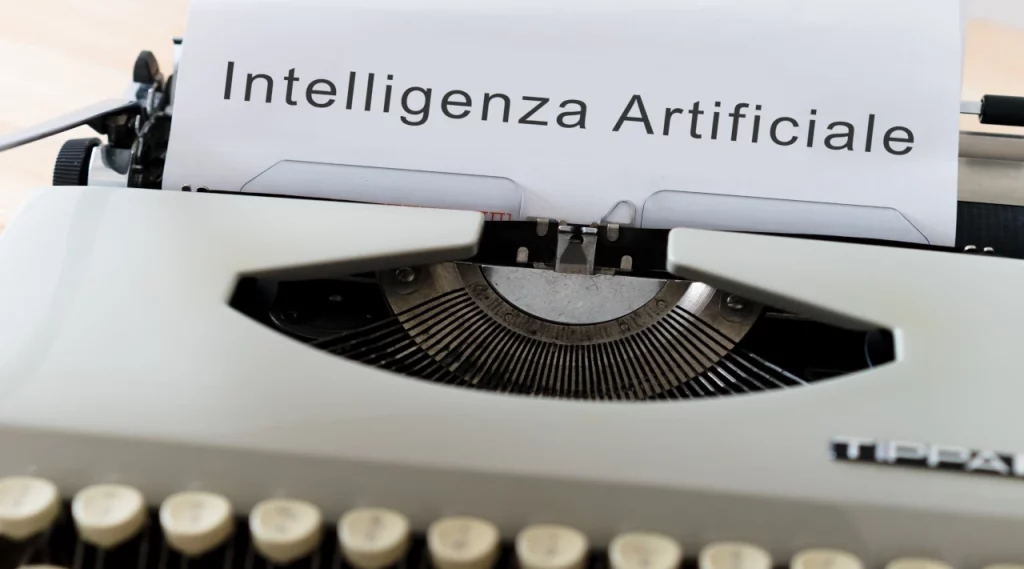 Macchina da scrivere con carta su cui è stampata la frase 'Intelligenza Artificiale'.